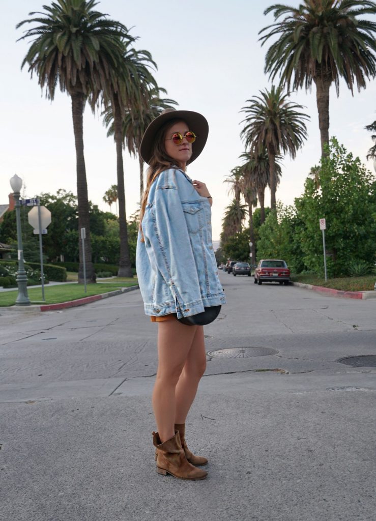 Andrea Steiner, fashion blogger from Strawberries 'n' Champagne based in Switzerland is wearing a romper with a jeans jacket, boots, bag and a self made hat